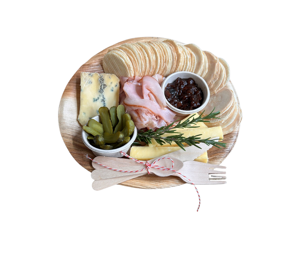 Platter with ham, cheeses, cornichons, chutney and crackers. 